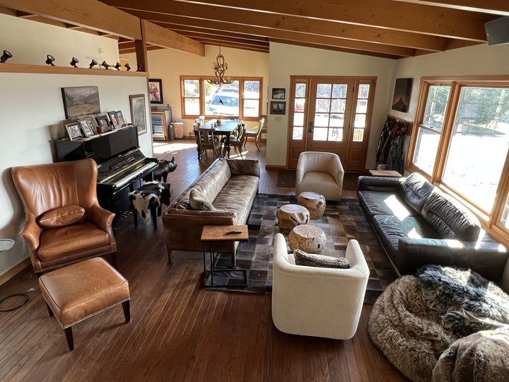 A warm, wood-beamed living room at the estate