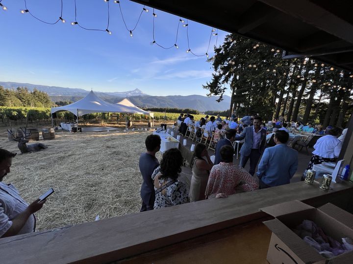 Guests gathered under string lights on an evening at the estate